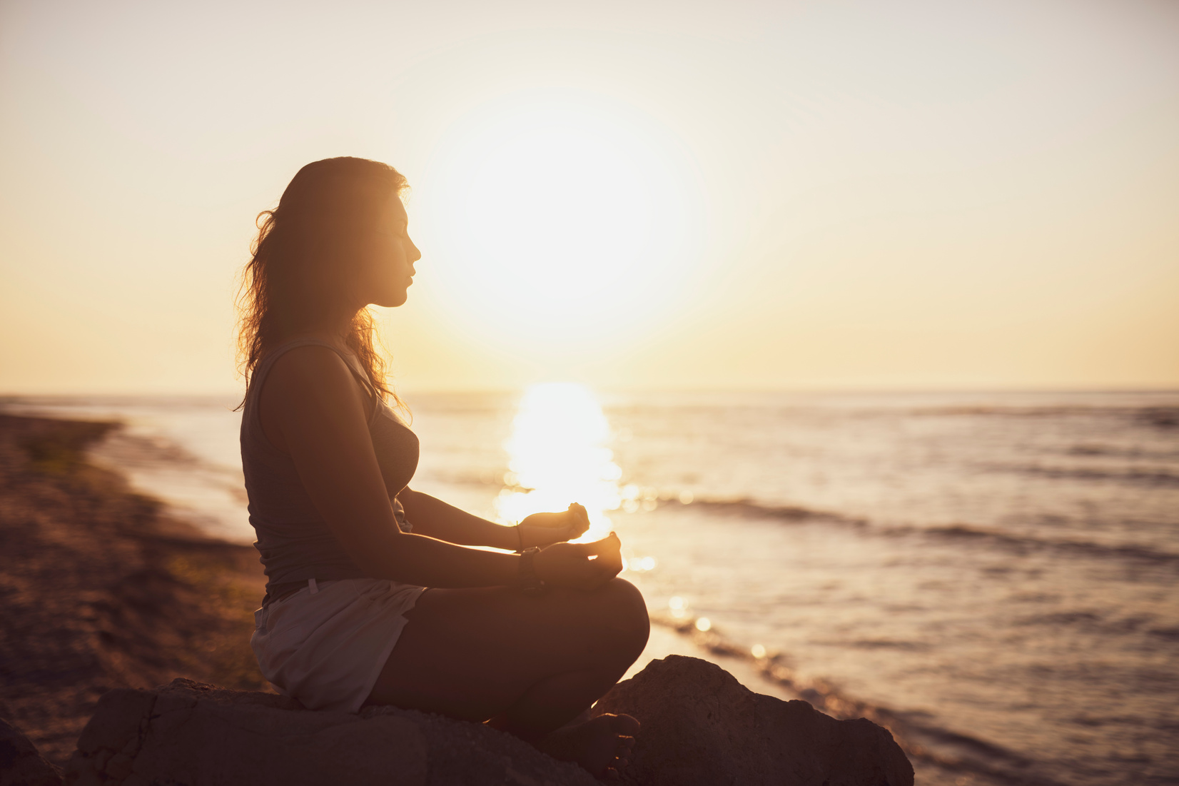 Woman meditation at sunrise.